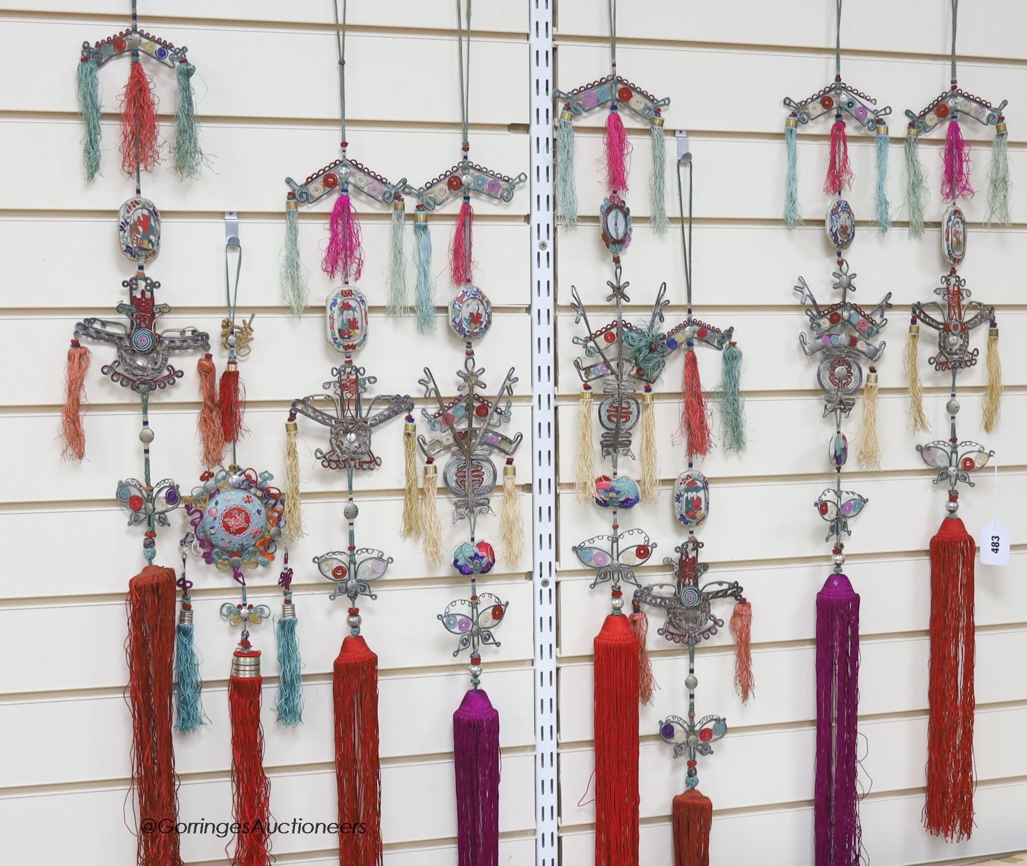 Eight 20th century Chinese embroidered, tasselled and wireworked ceremonial hangings, longest 130cm